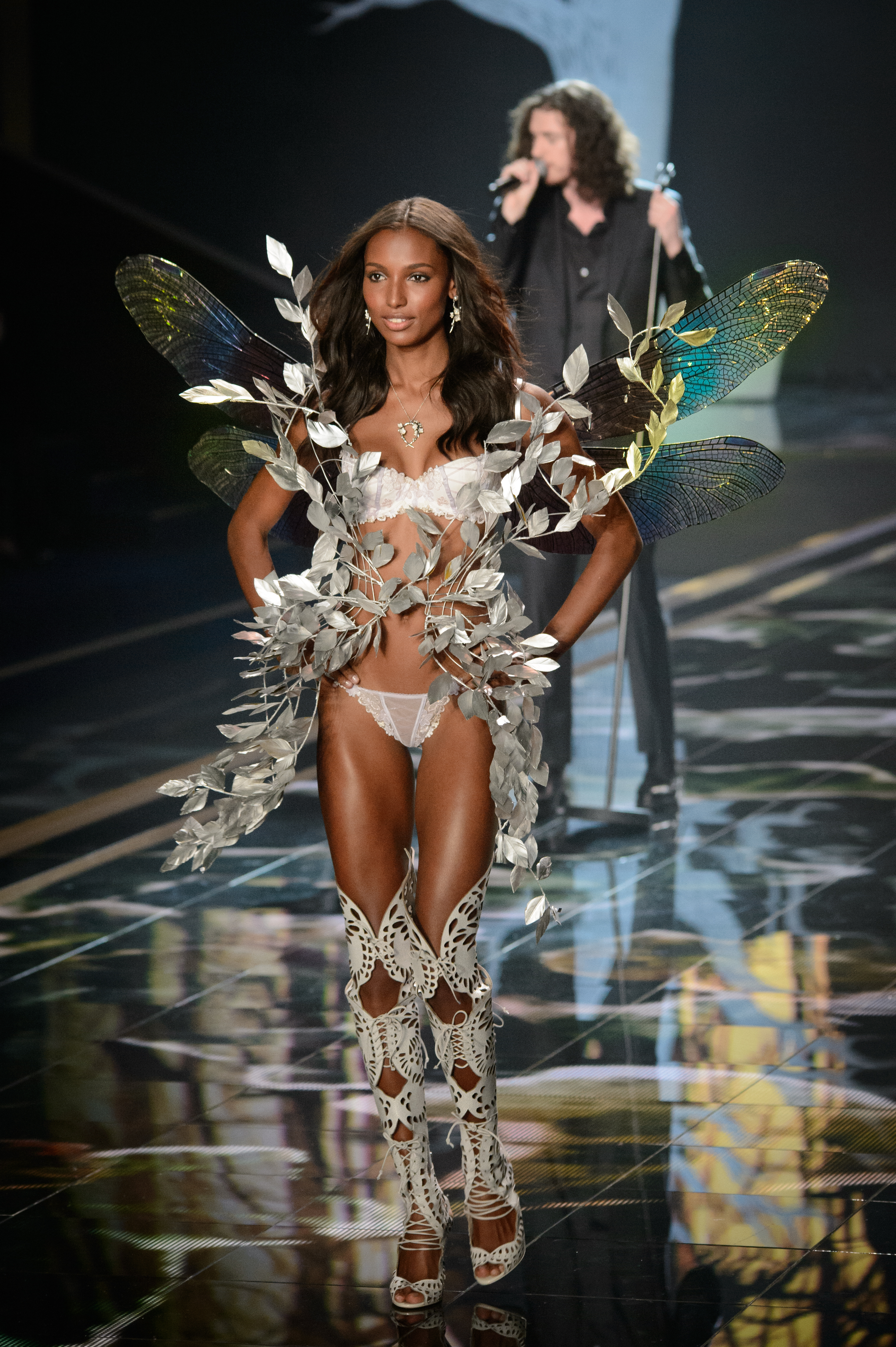 2014 archive: Jasmine Tookes walking the Victoria’s Secret runway in London, with her full outfit and wings visible.